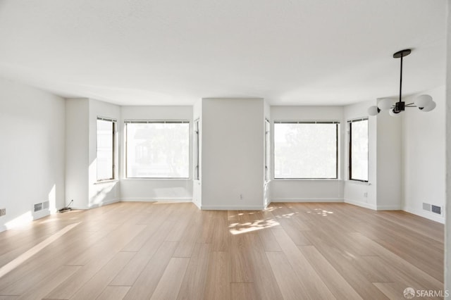 spare room with ceiling fan and light wood-type flooring