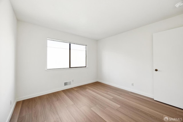 empty room with light hardwood / wood-style floors