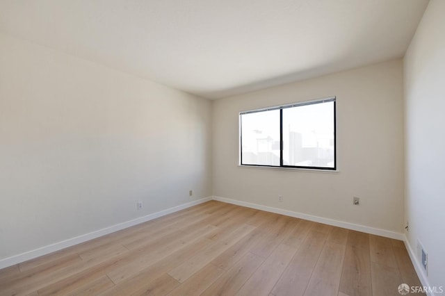 spare room featuring light hardwood / wood-style floors