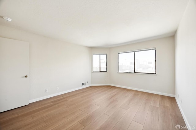 unfurnished room featuring light wood-type flooring