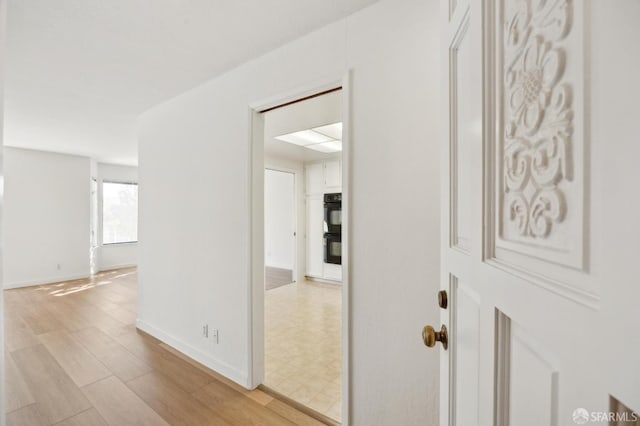 hall with light wood-type flooring