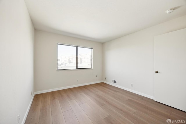 unfurnished room with light wood-type flooring