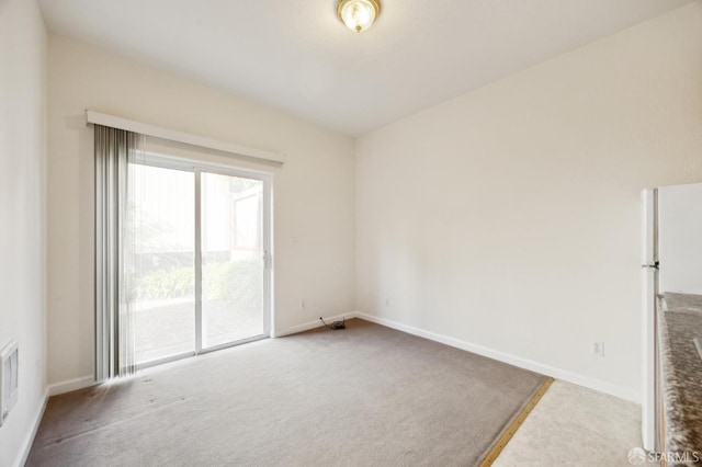 unfurnished room with light carpet