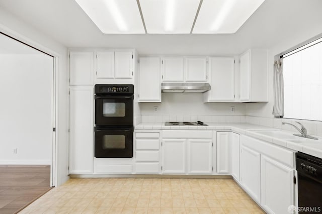 kitchen with white cabinetry, tile countertops, sink, and black appliances