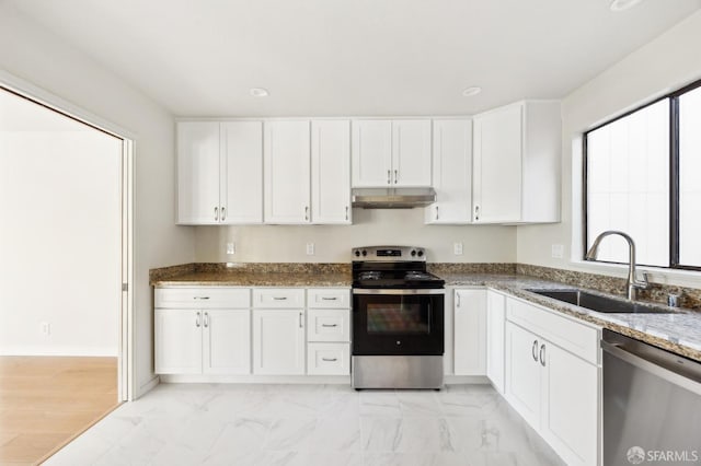 kitchen featuring white cabinetry, sink, stone counters, and appliances with stainless steel finishes