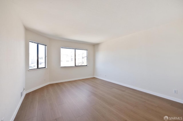 spare room featuring light hardwood / wood-style flooring