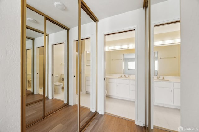 bathroom featuring vanity, hardwood / wood-style floors, and toilet