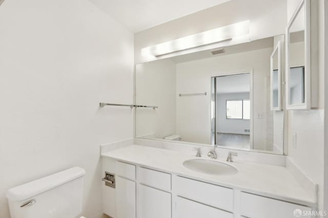 bathroom with vanity and toilet