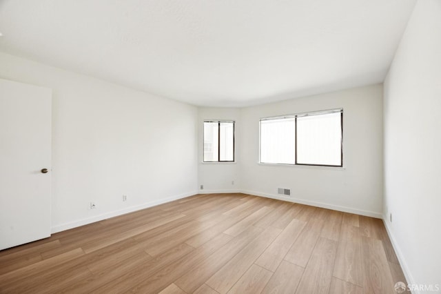 unfurnished room featuring light wood-type flooring