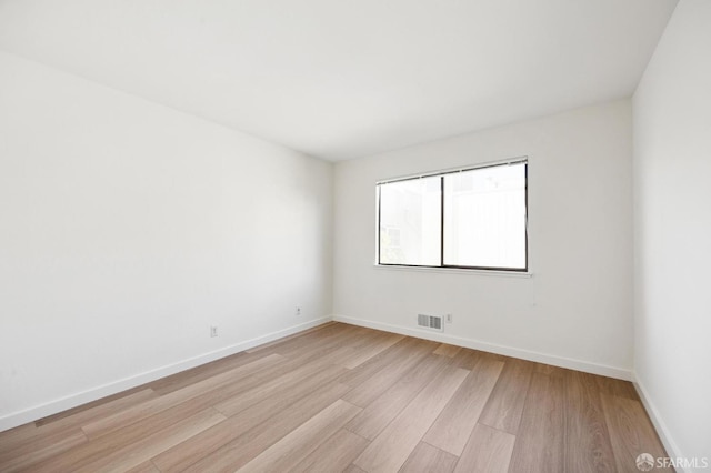 spare room featuring light hardwood / wood-style floors