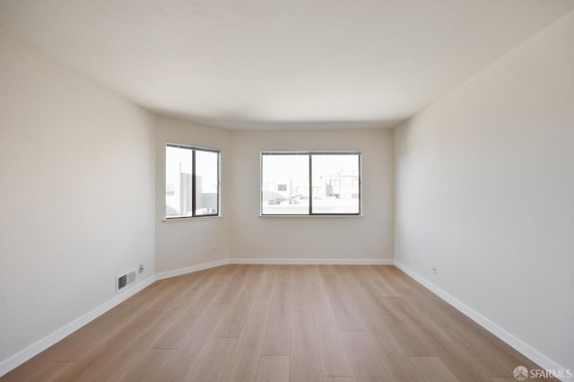 spare room featuring light hardwood / wood-style floors