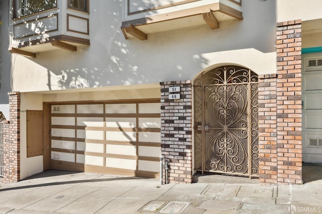 view of gate with a garage