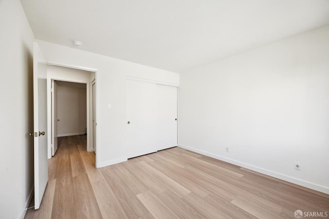 unfurnished room with light wood-type flooring