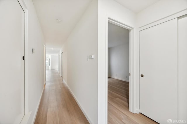 corridor with light hardwood / wood-style flooring