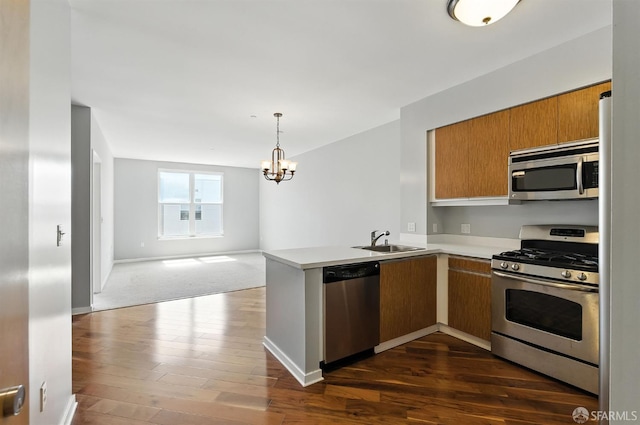 5800 3rd St Unit 1401, San Francisco, CA 94124 - kitchen featuring stainless steel appliances, open floor plan, light countertops, a peninsula, and a chandelier