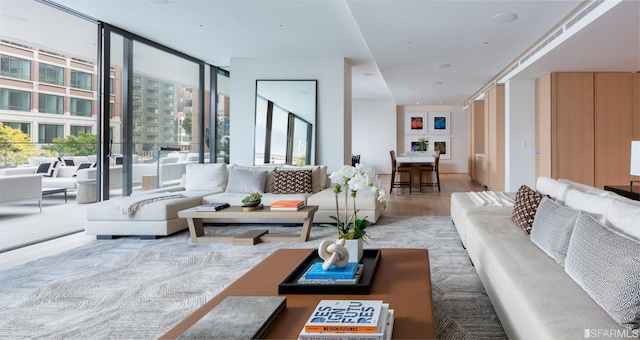 living room with floor to ceiling windows and wood finished floors