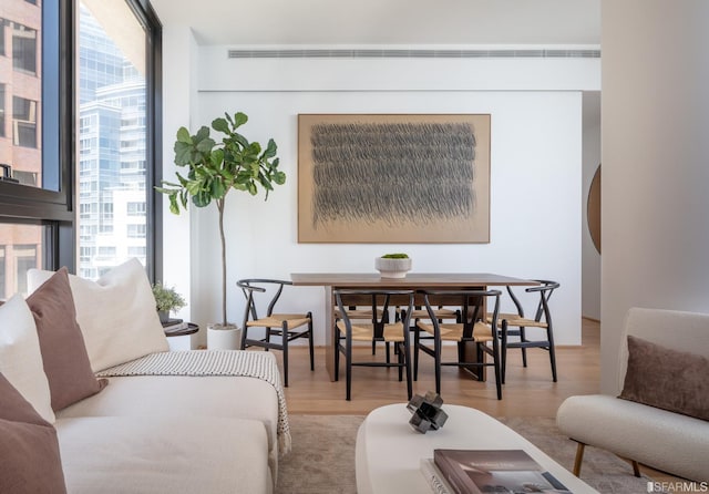 living area featuring wood finished floors and floor to ceiling windows