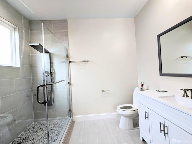 bathroom featuring vanity, toilet, and walk in shower