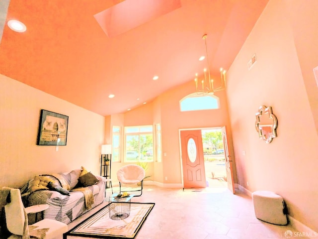 living room featuring a towering ceiling, light tile patterned floors, and an inviting chandelier