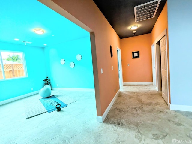 hallway with visible vents and baseboards