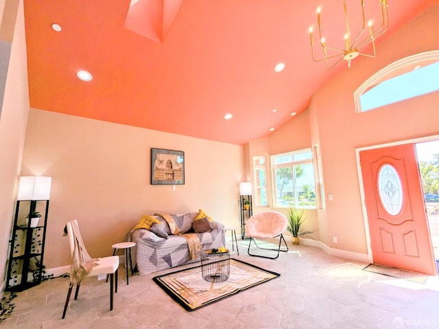 living room with baseboards, high vaulted ceiling, an inviting chandelier, and recessed lighting
