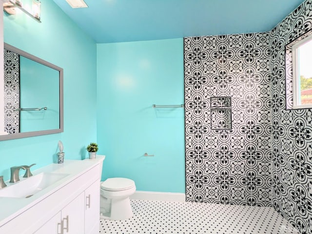 full bathroom with walk in shower, toilet, vanity, and baseboards