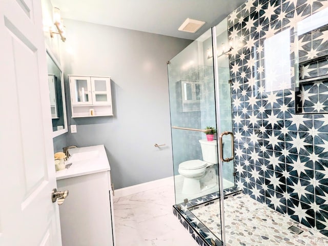 bathroom featuring vanity, toilet, and an enclosed shower