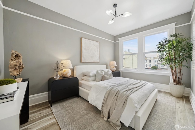 19 Card Aly, San Francisco, CA 94133 - bedroom featuring light wood-style flooring, a chandelier, and baseboards