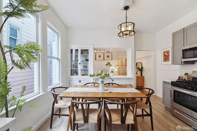 dining area featuring an inviting chandelier and light hardwood / wood-style flooring