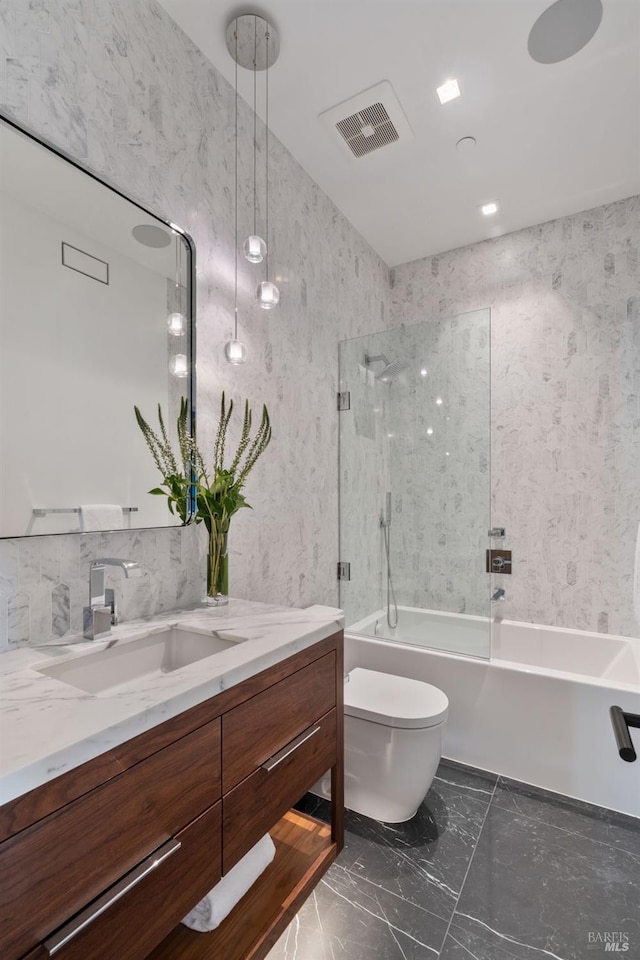 bathroom featuring visible vents, toilet, marble finish floor, tub / shower combination, and vanity