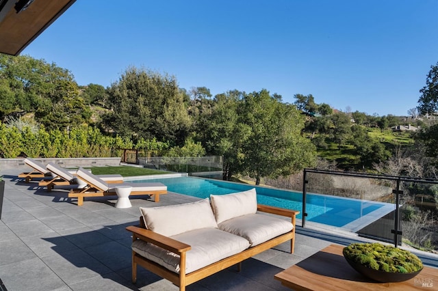 pool featuring fence and a patio