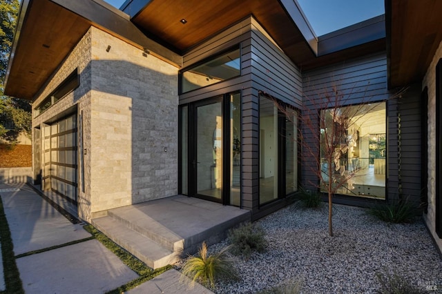 entrance to property featuring stone siding