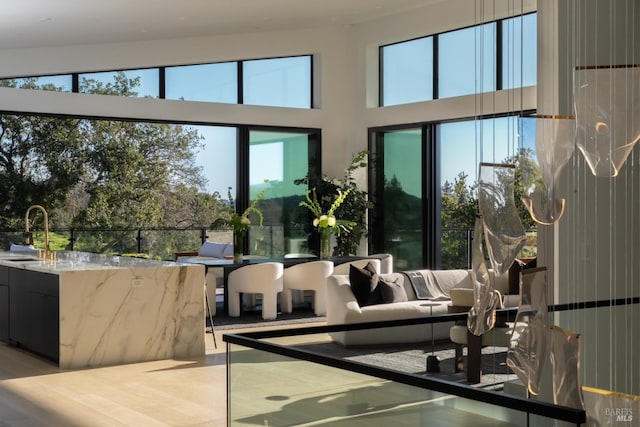 interior space featuring a high ceiling and a sink
