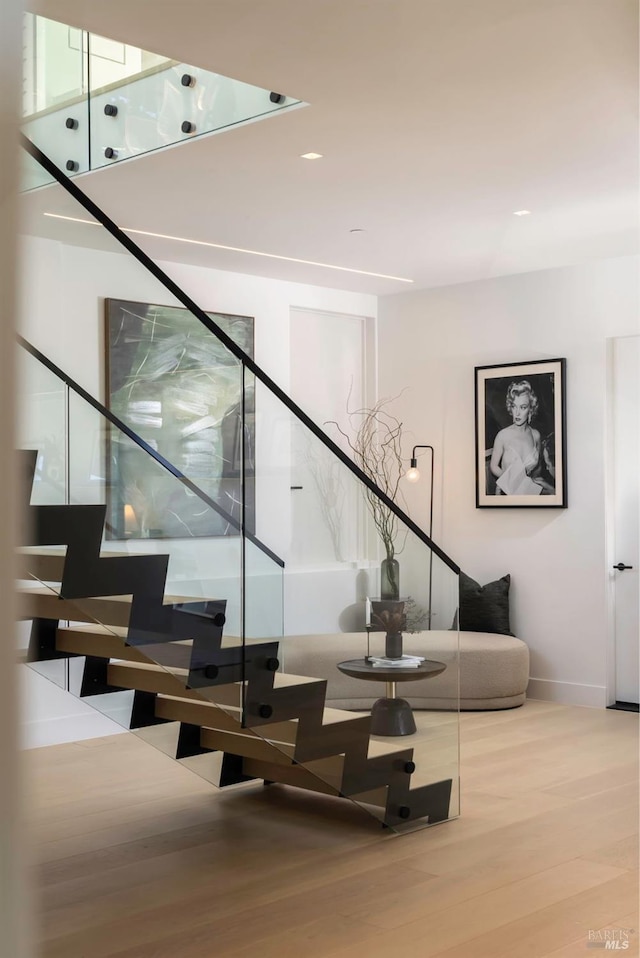staircase featuring wood finished floors