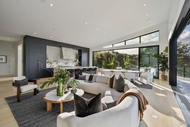 living area featuring light wood-type flooring and recessed lighting