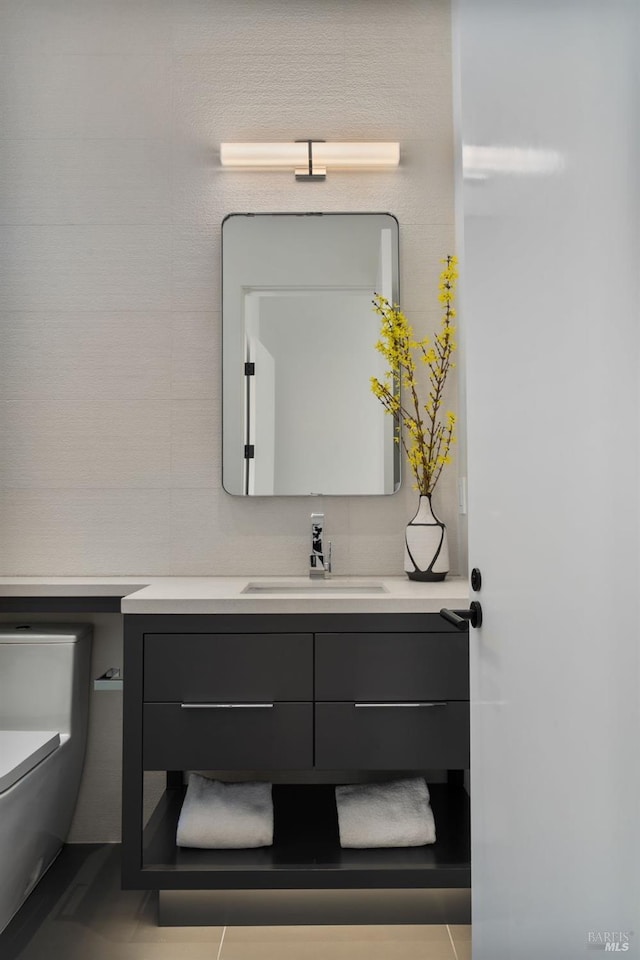 bathroom featuring toilet and vanity