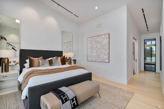 bedroom with light wood-style flooring and baseboards