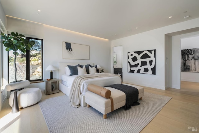 bedroom with light wood-type flooring, baseboards, and recessed lighting