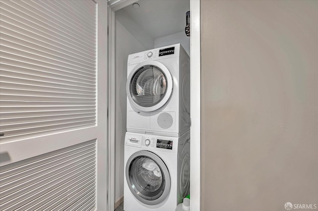 laundry area with stacked washer and dryer