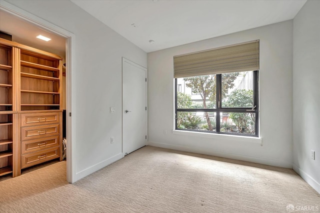 unfurnished bedroom featuring light colored carpet