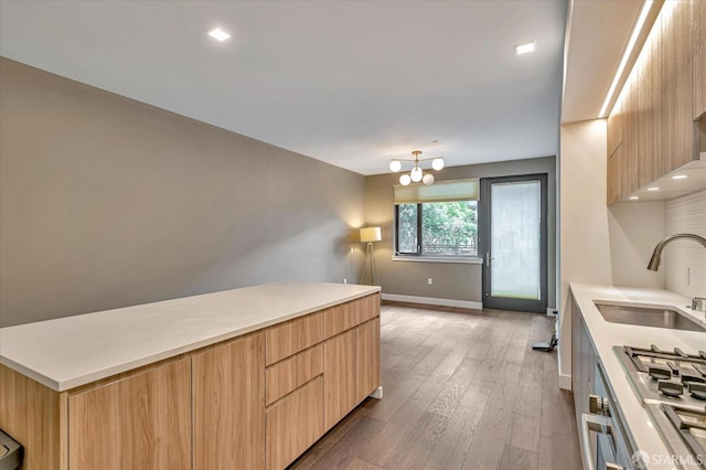 kitchen featuring a chandelier, light brown cabinetry, dark hardwood / wood-style floors, and sink