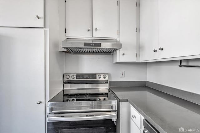 kitchen with dark countertops, stainless steel electric range, white cabinetry, and ventilation hood