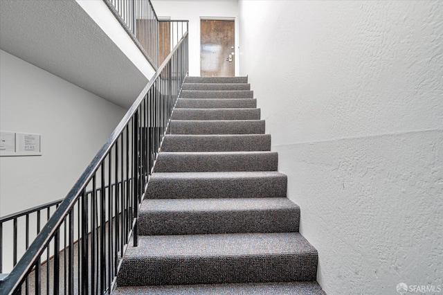 staircase with a textured wall