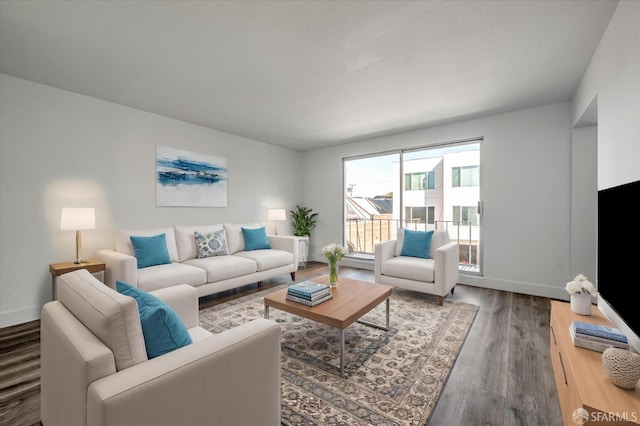 living area with wood finished floors and baseboards