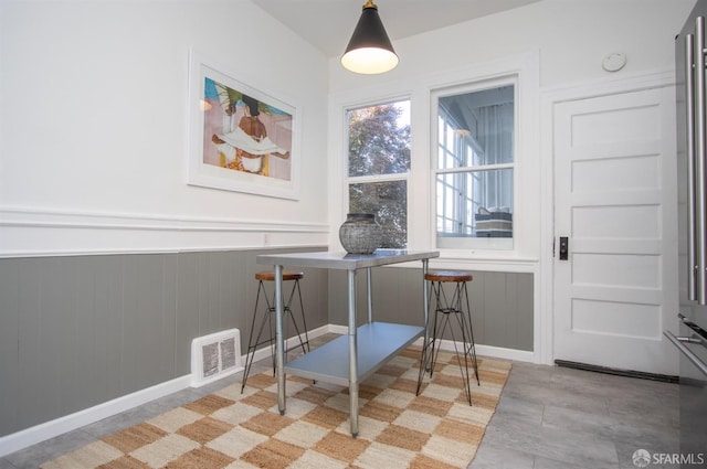 dining room with a wainscoted wall