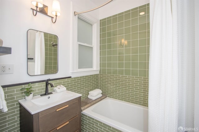 full bathroom featuring tile walls and vanity