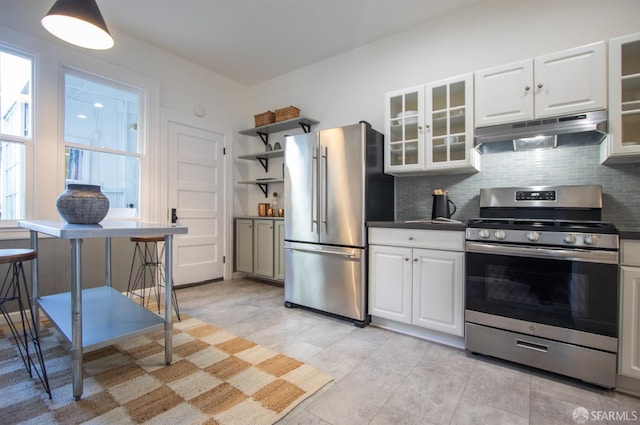 kitchen with appliances with stainless steel finishes, under cabinet range hood, decorative backsplash, and open shelves