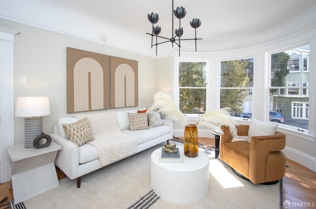 living area with a chandelier, healthy amount of natural light, and baseboards