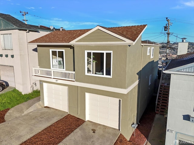 view of front of home featuring a balcony and a garage