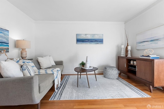 living room featuring ornamental molding, wood finished floors, and baseboards